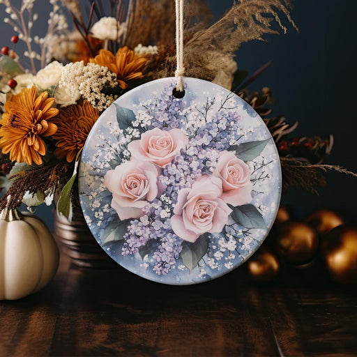 a ceramic ornament with pink roses and baby's breath