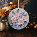 a ceramic ornament with pink roses and baby's breath