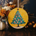 a yellow plate with a christmas tree painted on it