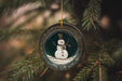 a snowman ornament hanging from a christmas tree