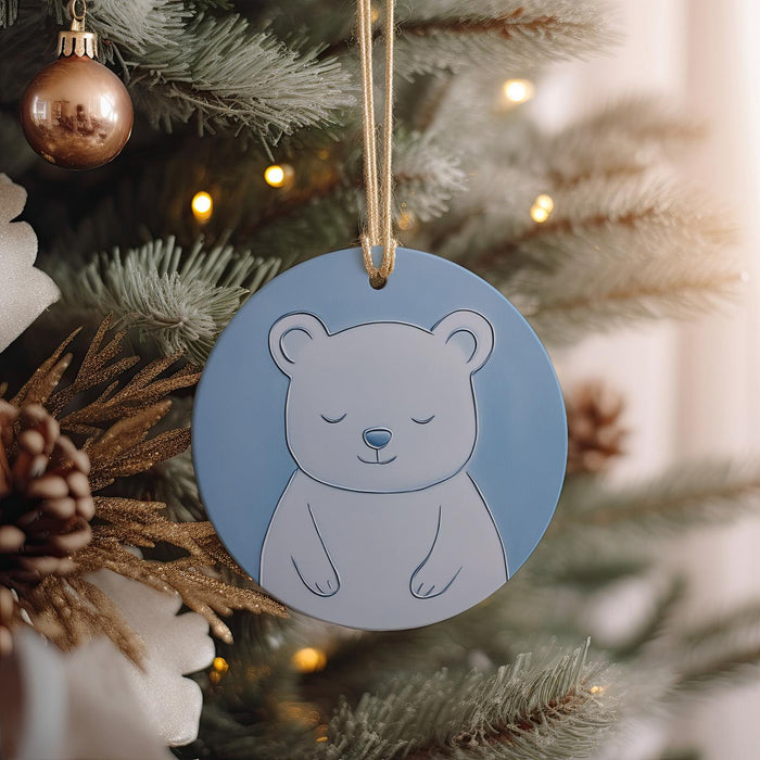 a blue ornament hanging from a christmas tree