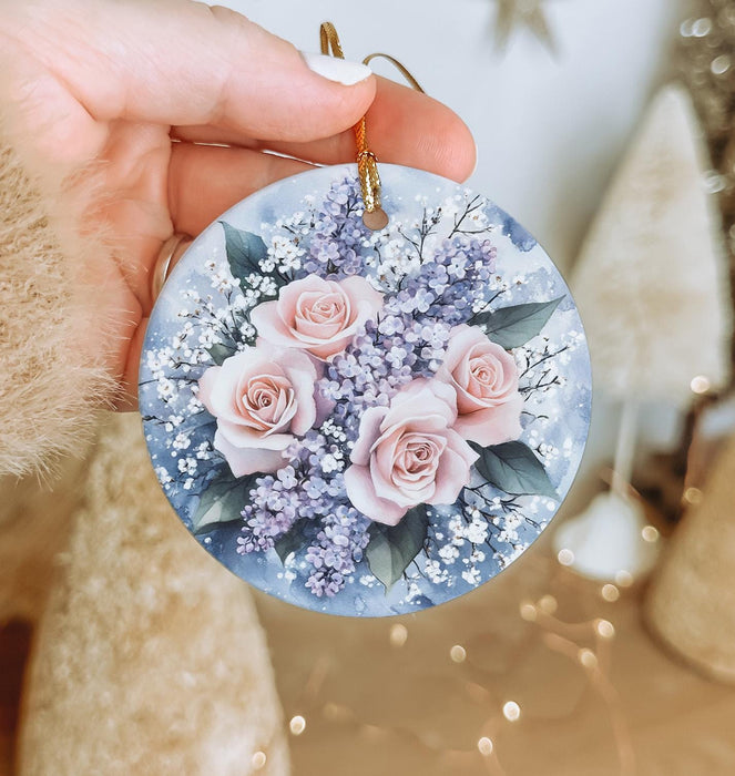a person holding a round ornament with flowers on it