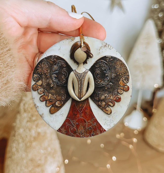 a person holding a christmas ornament in their hand