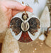 a person holding a christmas ornament in their hand