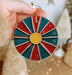 a person holding a christmas ornament in their hand