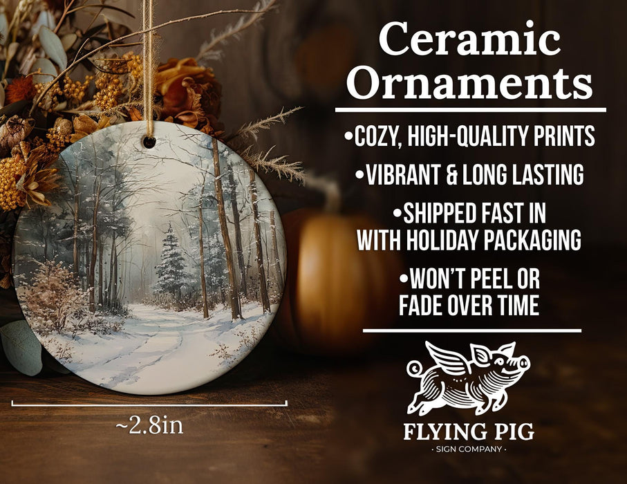 a ceramic ornament with a snowy forest scene