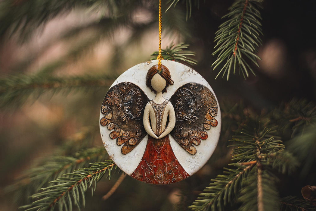 a ceramic angel ornament hanging from a christmas tree