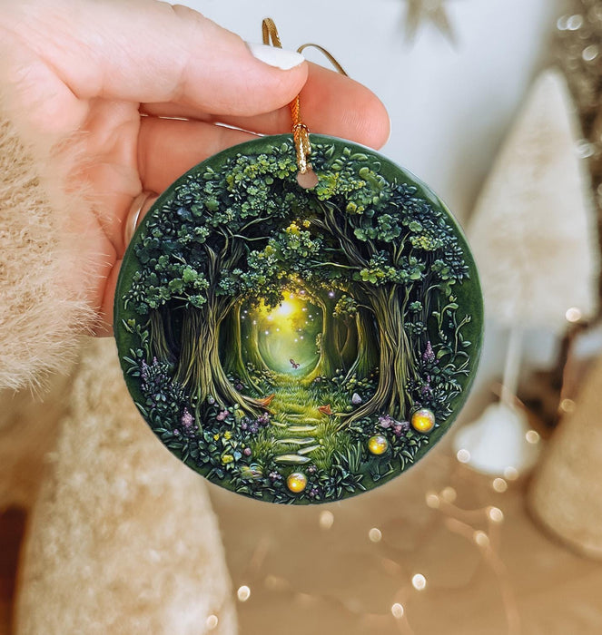 a hand holding a green ornament with a tree inside of it