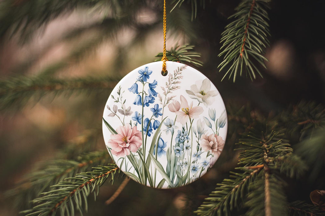 a ceramic ornament hanging from a pine tree