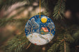 a ceramic ornament hanging from a christmas tree