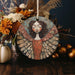 a ceramic angel ornament sitting on top of a table