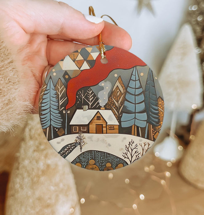a person holding a christmas ornament in their hand