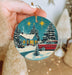 a person holding a christmas ornament in their hand