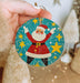 a person holding a christmas ornament in their hand