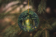 a christmas ornament hanging from a christmas tree