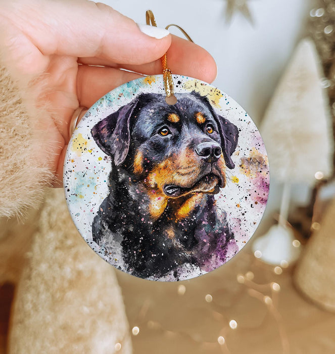 a hand holding a christmas ornament with a picture of a dog