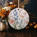 a ceramic ornament decorated with flowers and leaves