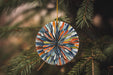 a glass ornament hanging from a christmas tree