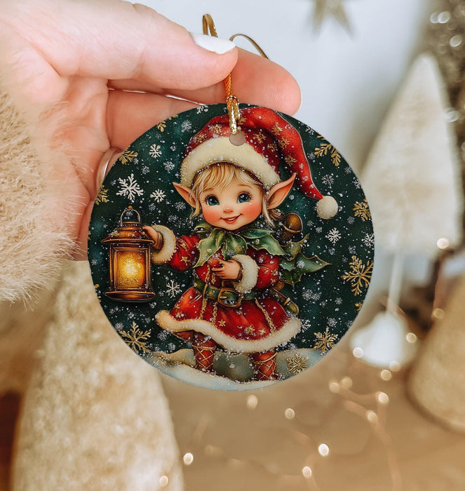 a person holding a christmas ornament in their hand