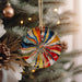a colorful ornament hanging from a christmas tree