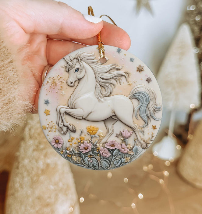 a hand holding a christmas ornament with a white horse on it