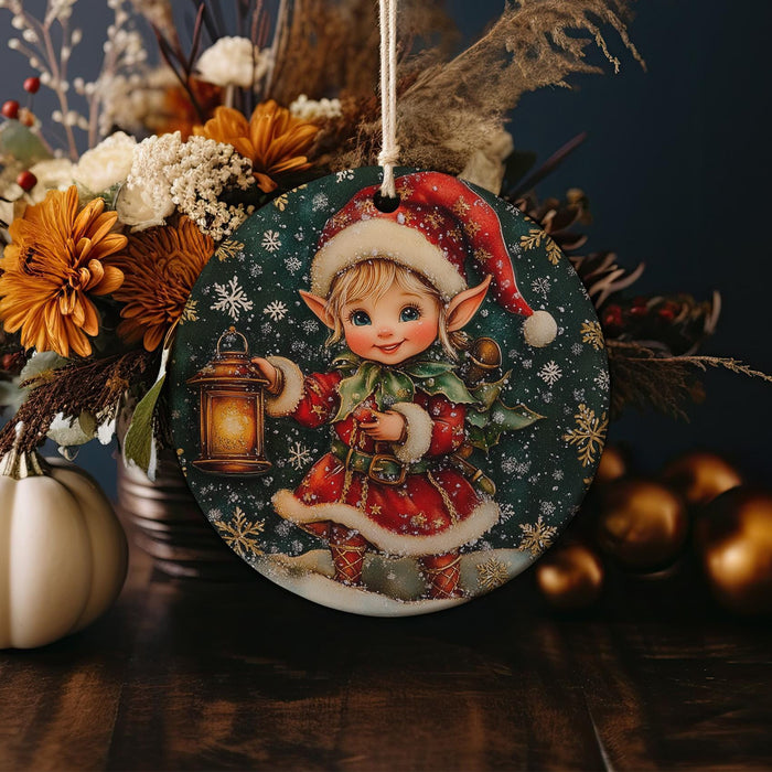 a christmas ornament with a little elf holding a lantern