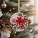 a christmas ornament hanging from a christmas tree