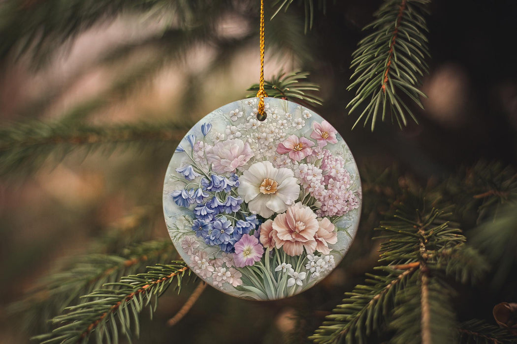 a glass ornament with flowers hanging from a tree