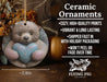 a ceramic ornament with a teddy bear holding a heart