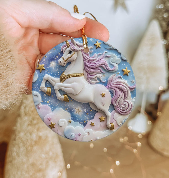 a hand holding a christmas ornament with a unicorn on it