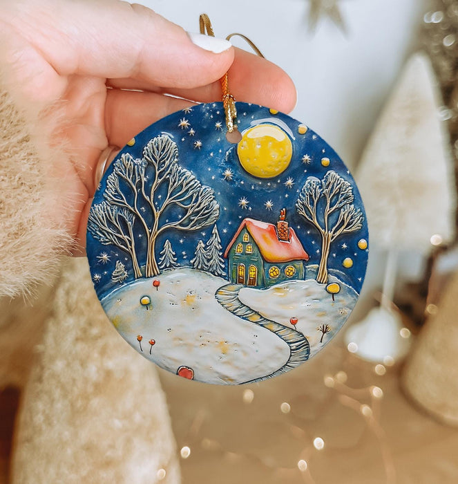a person holding a christmas ornament in their hand