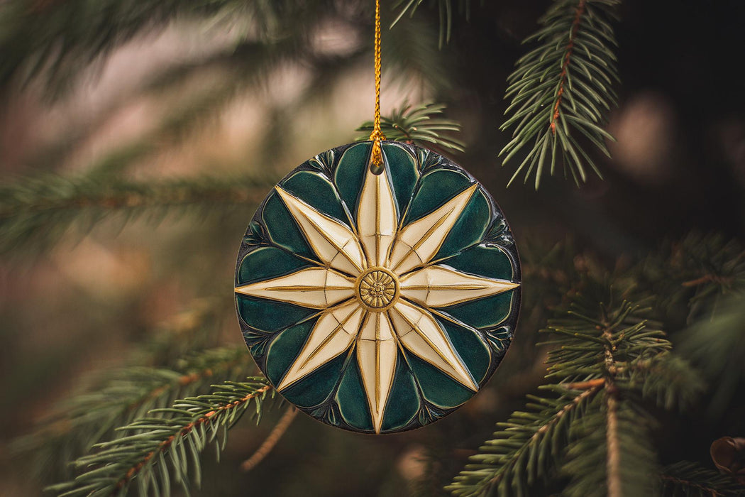 a green and white ornament hanging from a tree