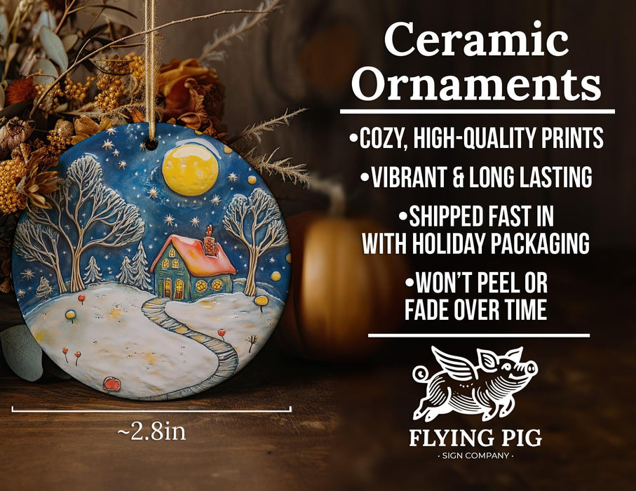 a ceramic christmas ornament with a snowy scene