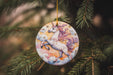 a ceramic ornament hanging from a christmas tree