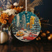 a christmas ornament with a city scene on it