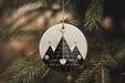 a christmas ornament hanging from a pine tree