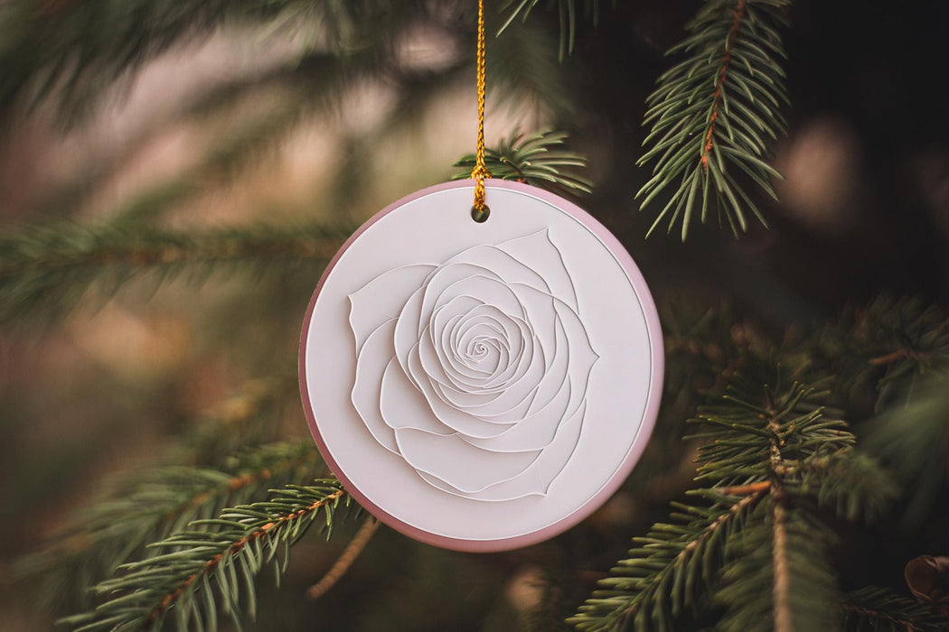 a white ornament hanging from a christmas tree
