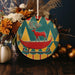 a christmas ornament with a deer on a sleigh