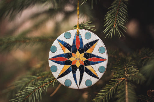 a ceramic ornament hanging from a christmas tree