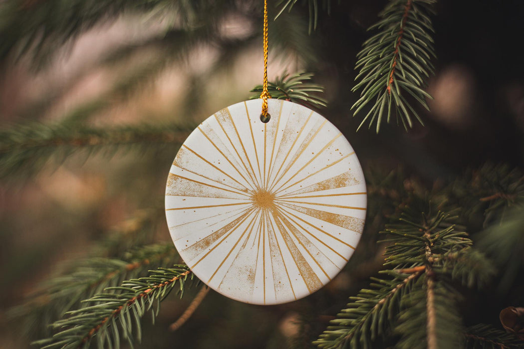 a white ornament hanging from a christmas tree