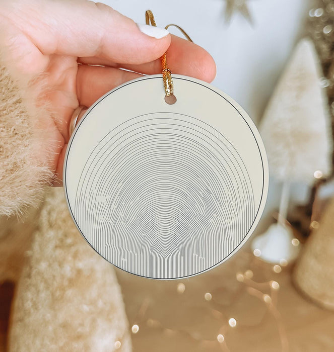 a person holding a round ornament in their hand
