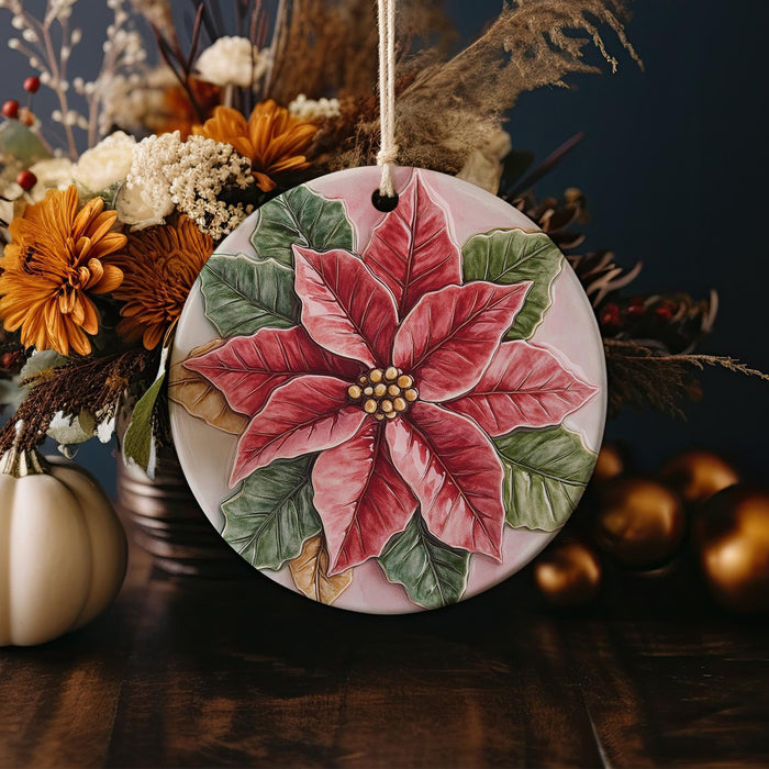 a ceramic ornament decorated with a poinsetti