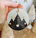 a person holding a christmas ornament in their hand