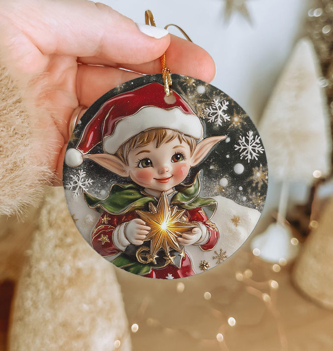 a hand holding a christmas ornament with a little elf on it