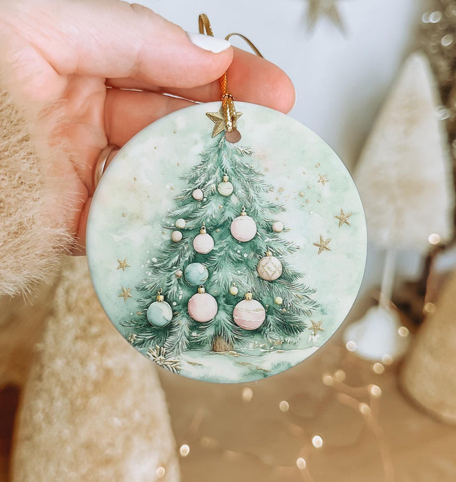 a person holding a christmas ornament in their hand