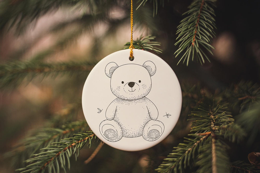 a white ornament hanging from a christmas tree