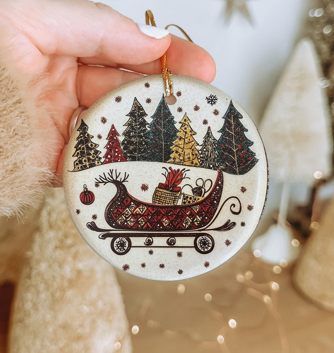 a person holding a christmas ornament in their hand