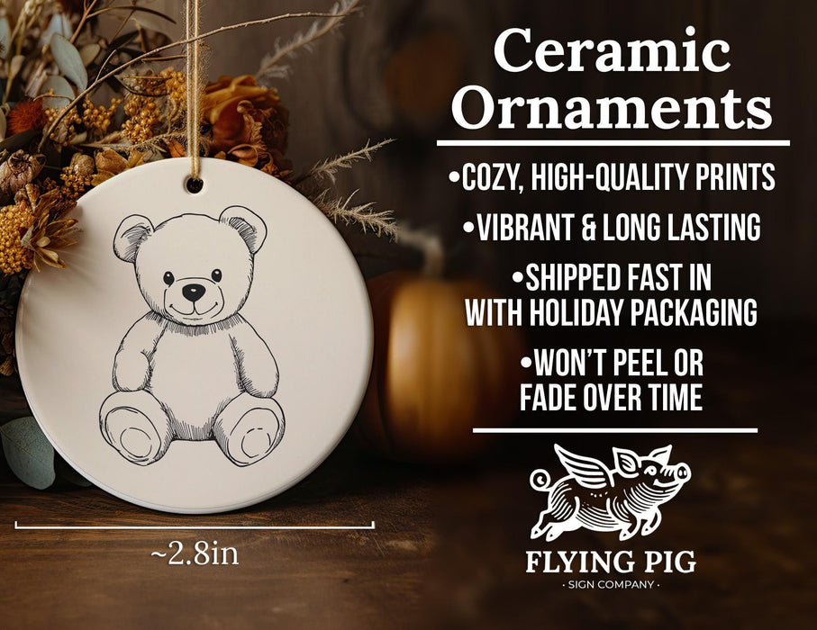 a ceramic ornament with a drawing of a teddy bear