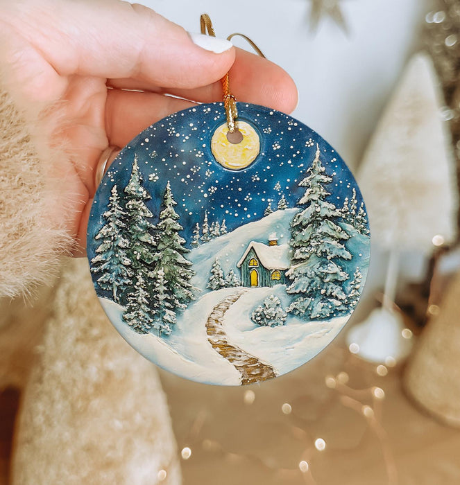 a person holding a christmas ornament in their hand
