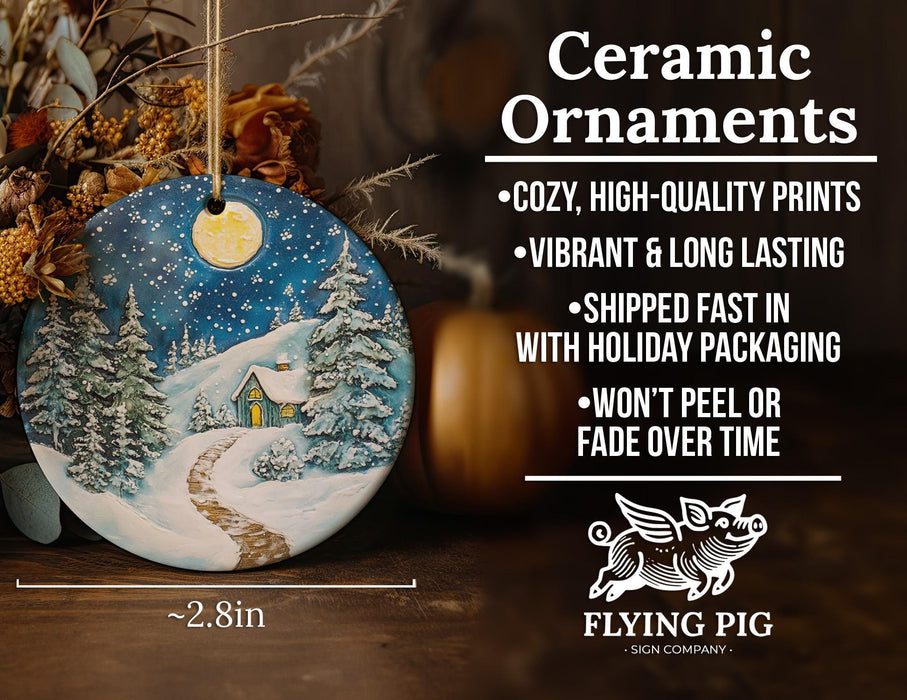 a ceramic christmas ornament with a snowy scene